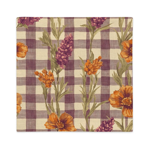 A square fabric pillow cover featuring a purple and beige gingham check pattern overlaid with orange poppy flowers and green stems.