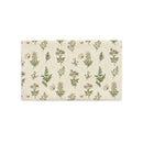 A rectangular placemat with a botanical pattern featuring green leaves, beige flowers, and small butterflies on a cream background, shown on a solid white background.