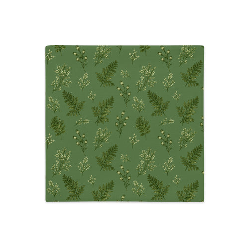 A square fabric or paper napkin featuring a repeating botanical pattern of green ferns and small white flowers on a muted sage green background, shown flat against a white backdrop.