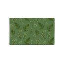 A rectangular placemat with a green background and a repeating pattern of delicate white and dark green wildflower illustrations, shown on a plain white background.