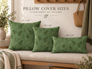 Three green patterned throw pillows displayed on a beige bench against a white wall, with overlaid size labels reading 22 x 22, 18 x 18, and 20 x 12. Text at the top says pillow cover sizes and pillow insert not included.