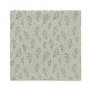 A square pillow cover with a repeating pattern of delicate olive green botanical stems on a muted sage green background, accented with tiny gold dots.