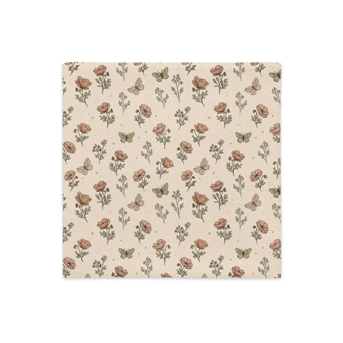 A square fabric napkin or paper towel featuring a vintage-style floral and butterfly pattern on a warm beige background.