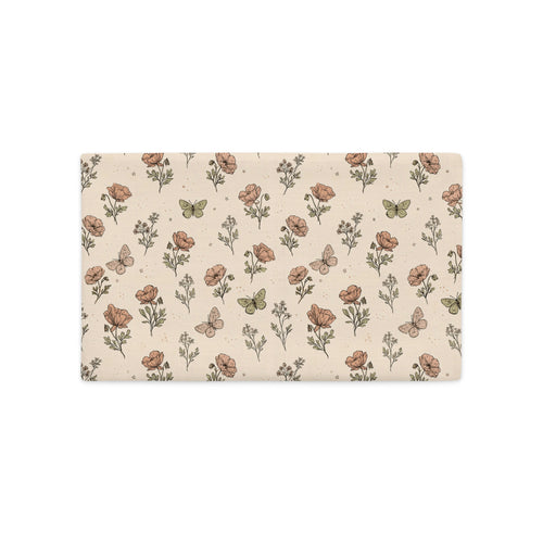 A rectangular fabric placemat or desk mat featuring a vintage-style botanical pattern with poppy flowers, wildflowers, and butterflies on a warm beige background.