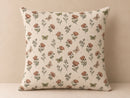A square decorative throw pillow with a vintage-style floral and butterfly print on a cream background, set against a neutral beige backdrop.