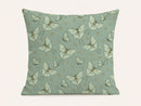 A square throw pillow featuring a repeating pattern of pale green and white luna moths on a muted sage green background, with tiny gold floral accents.